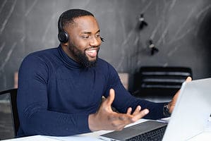 remote tech support image depicting a person of color helping someone remotely